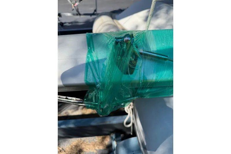 Slide: The Image of 2007 Hallett 33 boat detail with green protective wrap and metal components. - 24