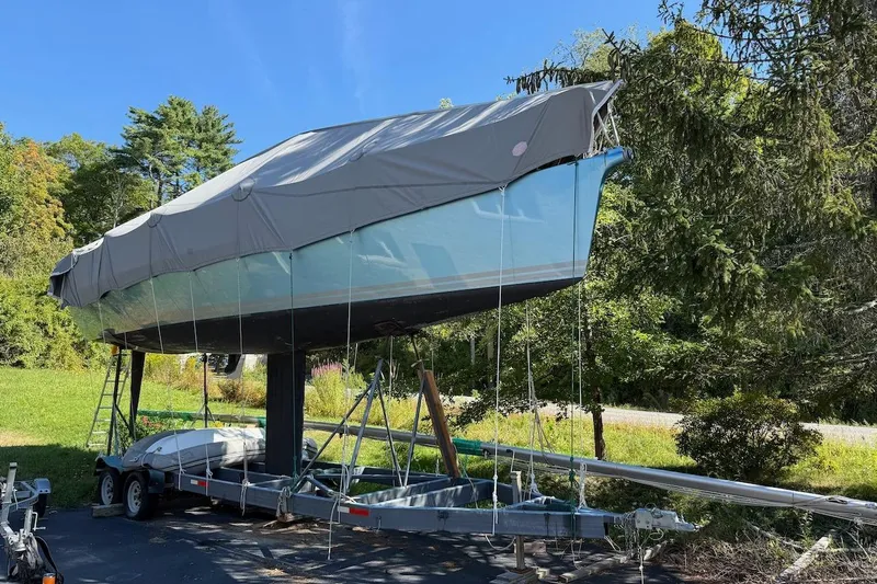 Slide: The Image of Covered 2007 Hallett 33 boat on trailer, surrounded by trees and greenery. - 30