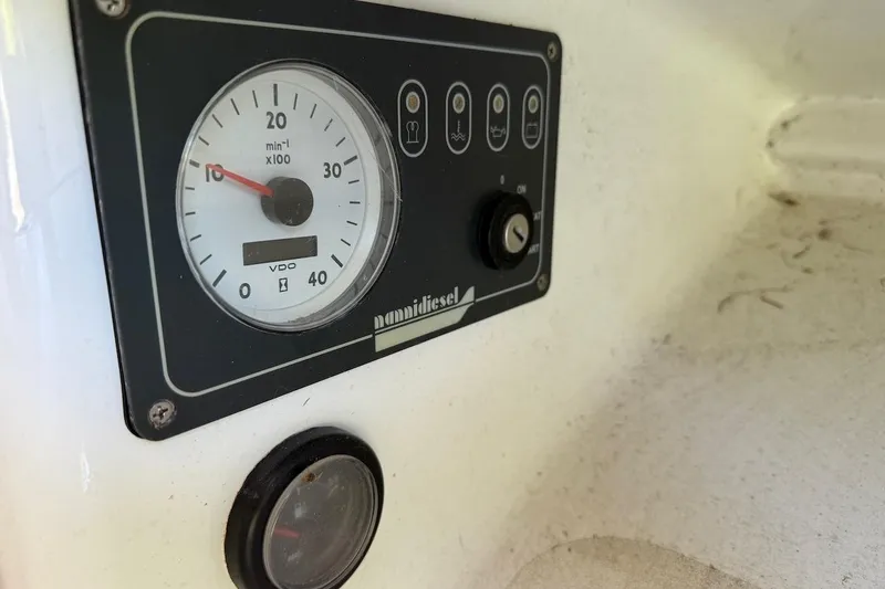 Slide: The Image of Dashboard of a 2007 Hallett 33 boat with gauges and controls. - 36