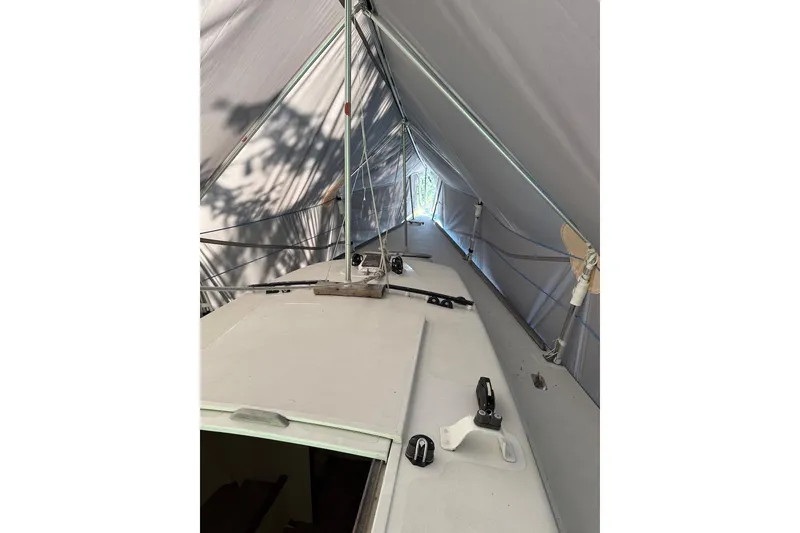 Slide: The Image of 2007 Hallett 33 boat under a protective canopy, showcasing deck and rigging. - 41