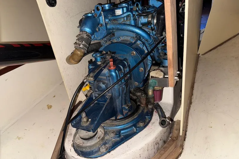 Slide: The Image of Engine compartment of a 2007 Hallett 33 boat, showcasing a blue marine engine. - 44