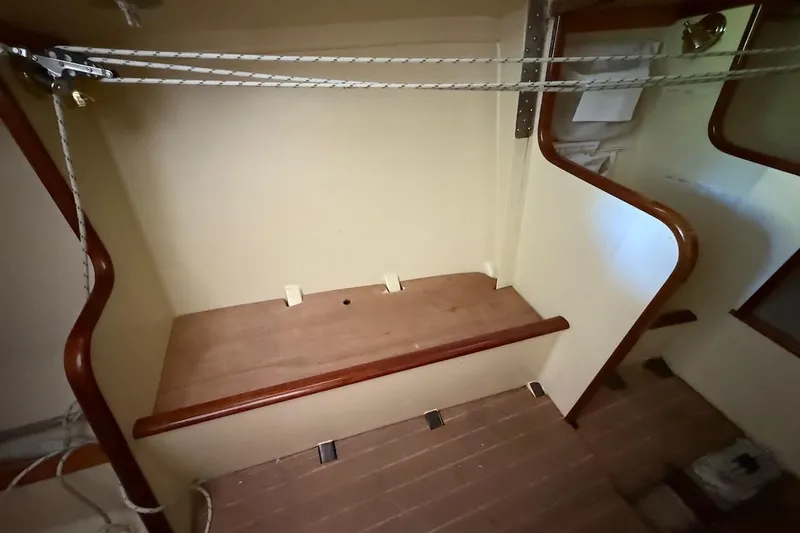 Slide: The Image of Interior of a 2007 Hallett 33 boat with wooden steps and rope details. - 50