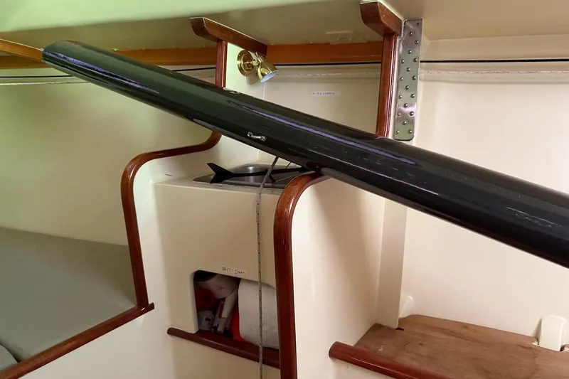 Slide: The Image of Interior of a 2007 Hallett 33 boat, featuring wooden accents and storage compartments. - 53