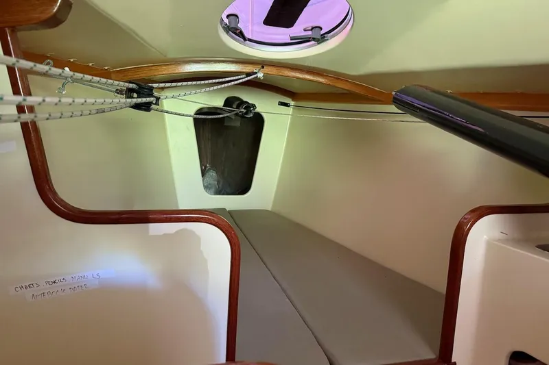 Slide: The Image of Interior cabin of a 2007 Hallett 33 boat with wooden trim and seating area. - 54