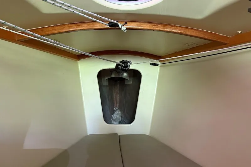 Slide: The Image of Interior of a 2007 Hallett 33 boat cabin with wooden accents and ropes. - 55