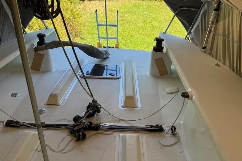 Slide: The Image of 2007 Hallett 33 boat deck with ropes and equipment, grassy background. - 56