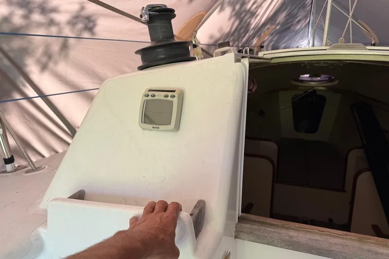 Slide: The Image of Hand on 2007 Hallett 33 sailboat deck with navigation equipment. - 60