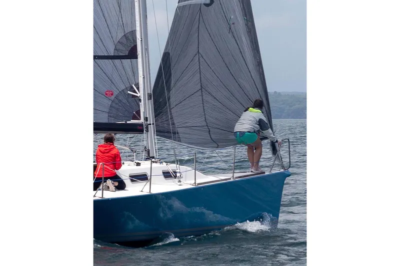 Slide: The Image of 2007 Hallett 33 sailboat with crew navigating on open water. - 8