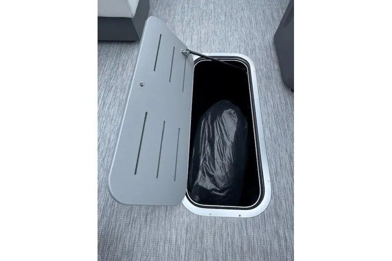 Slide: The Image of Storage compartment on 2026 Bennington 22 SSR boat with open lid and interior view. - 10