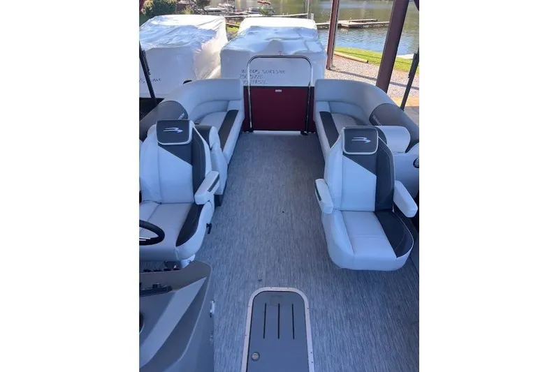 Slide: The Image of 2026 Bennington 22 SSR pontoon boat interior with stylish seating and lake view. - 7