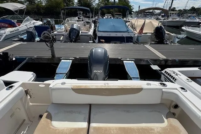 Slide: The Image of 2018 Robalo R222 Explorer boat docked at marina with other vessels. - 13