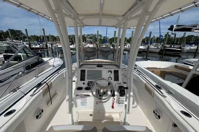 Slide: The Image of 2018 Robalo R222 Explorer boat interior at marina, showcasing helm and controls. - 3