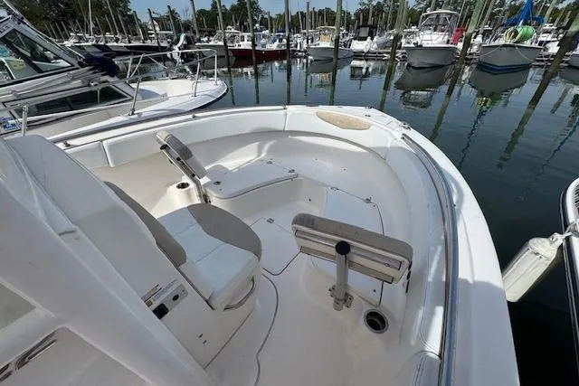 Slide: The Image of 2018 Robalo R222 Explorer boat interior at marina, featuring seating and clean design. - 4