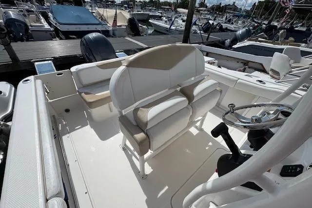 Slide: The Image of 2018 Robalo R222 Explorer boat interior with dual seats and steering wheel at marina. - 5
