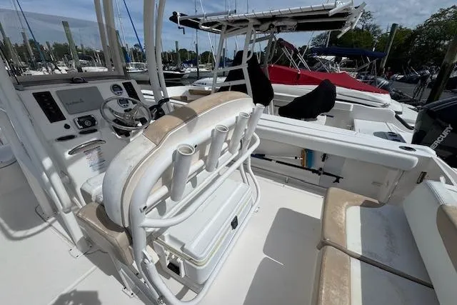 Slide: The Image of 2018 Robalo R222 Explorer boat interior with helm, seating, and rod holders. - 8