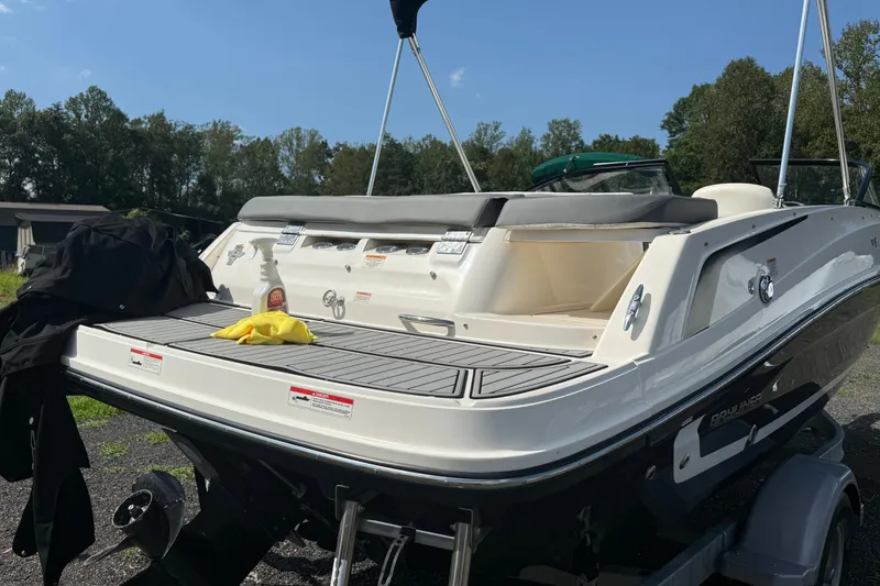 Slide: The Image of 2019 Bayliner VR5 Bowrider I/O boat with cleaning supplies on deck, parked outdoors. - 11