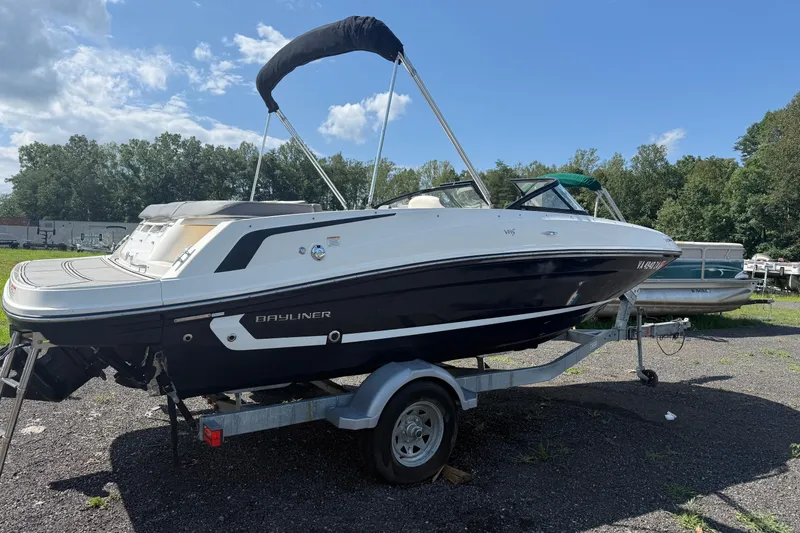 Slide: The Image of 2019 Bayliner VR5 Bowrider I/O on trailer, parked outdoors under clear sky. - 2
