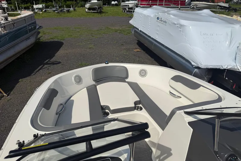 Slide: The Image of 2019 Bayliner VR5 Bowrider I/O boat interior with seating and windshield, parked outdoors. - 4
