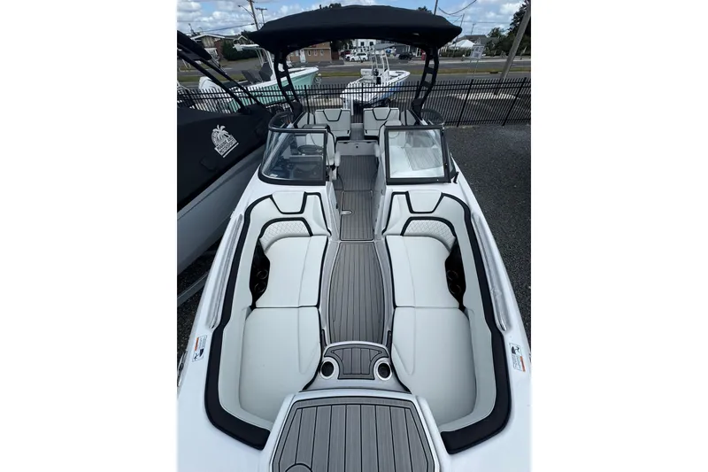 Slide: The Image of Manufacturer Provided Image: 2026 Yamaha Boats 252SD cruising on a lake with passengers, surrounded by lush greenery. - 7