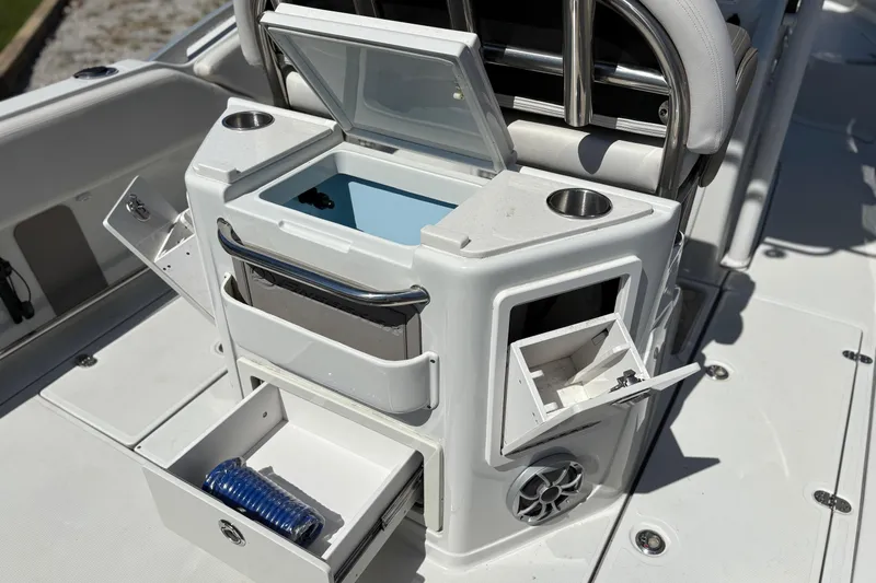 Slide: The Image of 2023 Finseeker 230cc boat console with storage compartments and cup holders. - 12