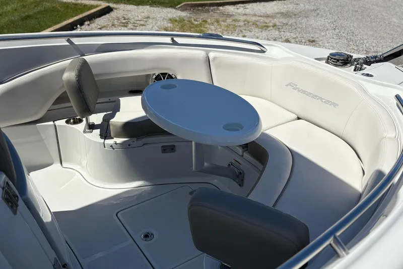 Slide: The Image of 2023 Finseeker 230cc boat interior with seating and table, showcasing luxury design. - 17