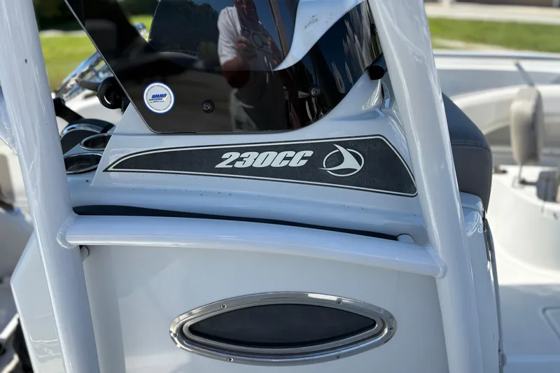 Slide: The Image of 2023 Finseeker 230cc boat console with logo and sleek design details. - 18