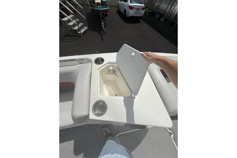 Slide: The Image of 2019 Hurricane SunDeck Sport 188 OB boat with open storage compartment and cup holders. - 11