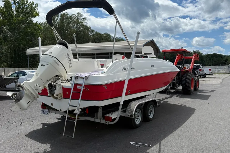 Slide: The Image of 2019 Hurricane SunDeck Sport 188 OB boat on trailer, with Suzuki outboard motor. - 2