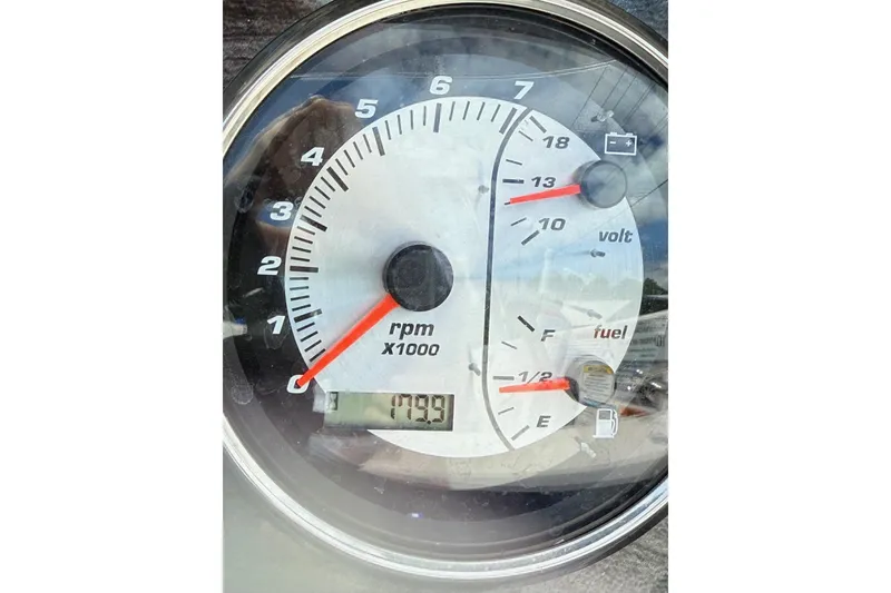 Slide: The Image of Close-up of 2019 Hurricane SunDeck Sport 188 OB boat gauge showing RPM, voltage, and fuel levels. - 8