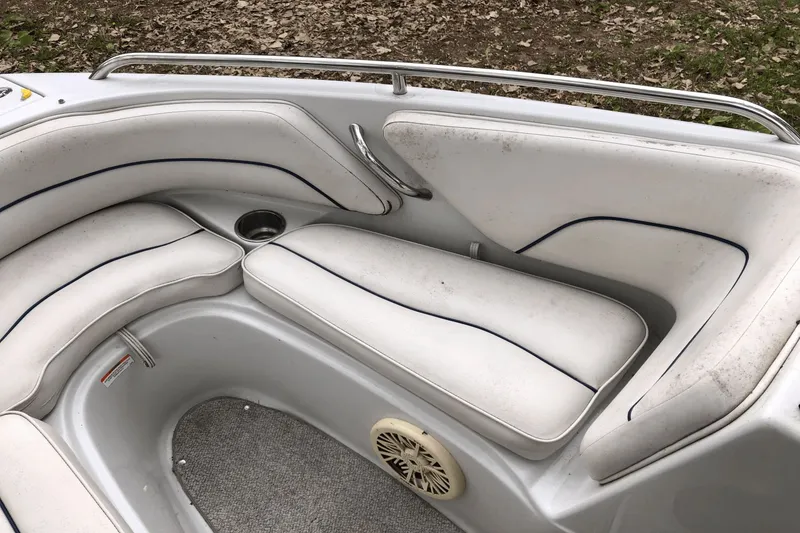 Slide: The Image of 2008 Crownline 19 SS boat interior with white cushioned seating and speaker. - 14