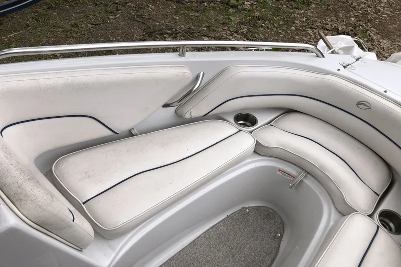 Slide: The Image of 2008 Crownline 19 SS boat interior with white cushioned seating and cup holders. - 15