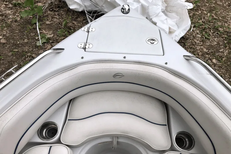 Slide: The Image of 2008 Crownline 19 SS boat interior with white seating and cup holders. - 16