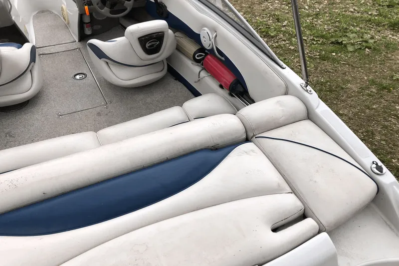 Slide: The Image of 2008 Crownline 19 SS boat interior with white and blue seating, steering wheel, and carpeted floor. - 25