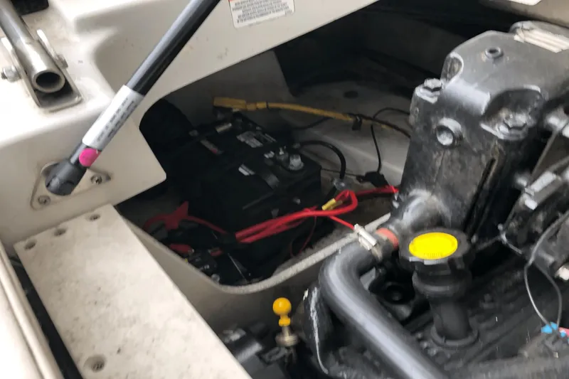 Slide: The Image of Engine compartment of a 2008 Crownline 19 SS boat, showing battery and components. - 32