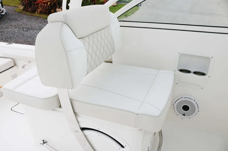 Slide: The Image of 2026 World Cat 230 DC boat interior with white cushioned seating and cup holders. - 12