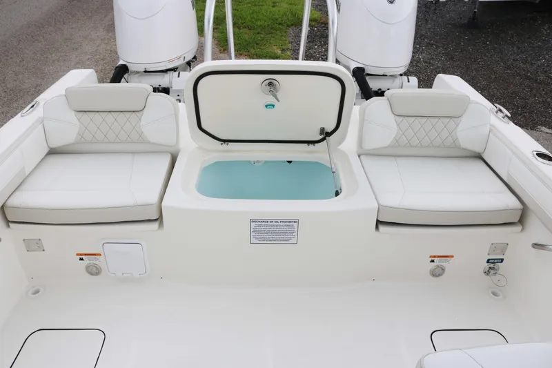 Slide: The Image of 2026 World Cat 230 DC boat interior with cushioned seating and storage compartment. - 17