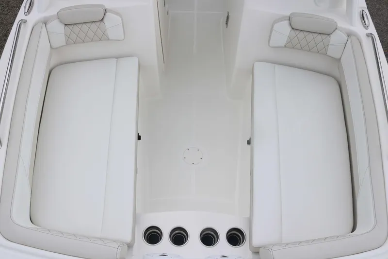 Slide: The Image of 2026 World Cat 230 DC boat interior with white cushioned seating and diamond stitching. - 9