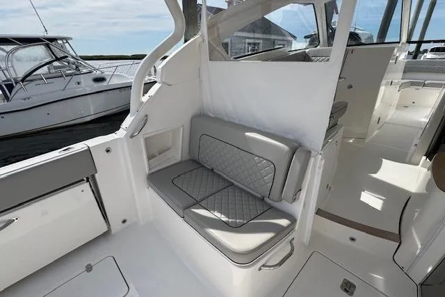 Slide: The Image of 2025 Pursuit DC 365 Dual Console interior with cushioned seating and modern design. - 14