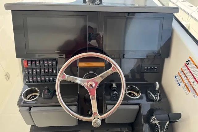 Slide: The Image of Helm of 2025 Pursuit DC 365 Dual Console with dual screens and controls. - 22