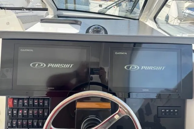 Slide: The Image of 2025 Pursuit DC 365 Dual Console dashboard with dual Garmin displays and steering wheel. - 27