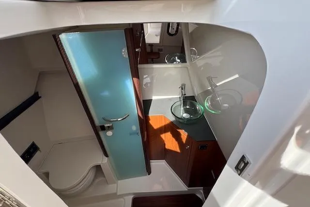 Slide: The Image of 2025 Pursuit DC 365 Dual Console boat interior with modern bathroom amenities. - 31