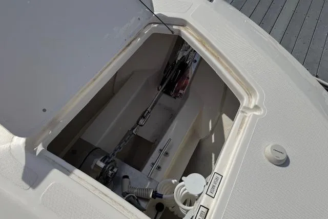 Slide: The Image of 2025 Pursuit DC 365 Dual Console anchor compartment with chain and winch system. - 37