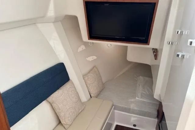 Slide: The Image of 2025 Pursuit DC 365 Dual Console cabin with seating, bed, and TV. - 40