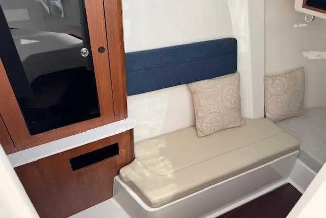 Slide: The Image of Interior of 2025 Pursuit DC 365 Dual Console with cushioned seating and wooden cabinetry. - 41