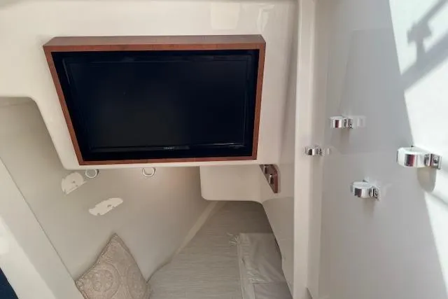 Slide: The Image of 2025 Pursuit DC 365 Dual Console interior with mounted TV and cozy seating area. - 45