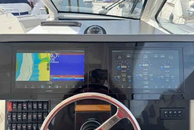Slide: The Image of 2025 Pursuit DC 365 Dual Console dashboard with Garmin navigation displays. - 46