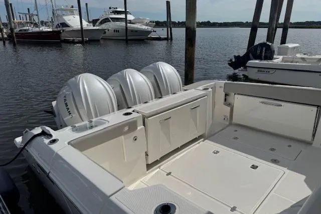 Slide: The Image of 2025 Pursuit DC 365 Dual Console boat with triple Yamaha engines docked in marina. - 6