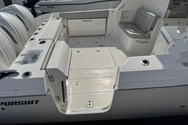 Slide: The Image of 2025 Pursuit DC 365 Dual Console boat with spacious deck and seating area. - 7