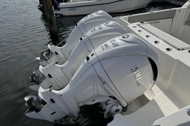 Slide: The Image of Triple Yamaha outboard engines on a 2025 Pursuit DC 365 Dual Console boat. - 8
