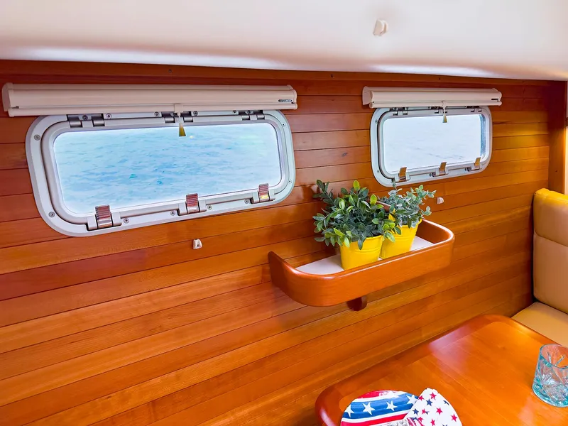 Slide: The Image of Interior of 2012 MJM 40z Downeast boat with wooden paneling and porthole windows. - 25